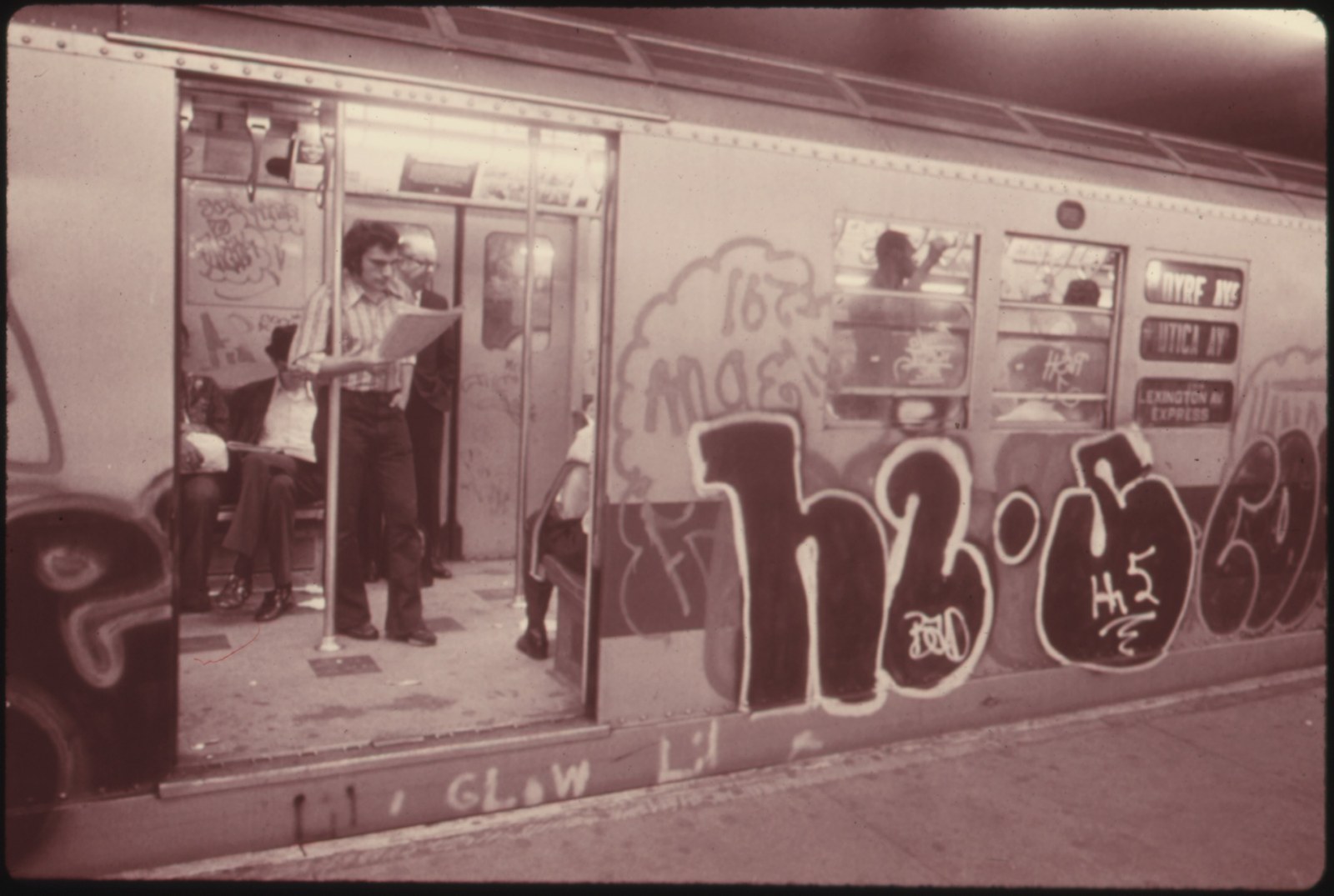 Graffiti-covered Lexington Avenue subway car at a platform in July 1974